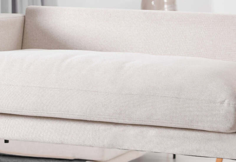 Delivery professionals carefully carrying a sofa into a home representing same-day furniture delivery service by My Home Delivery